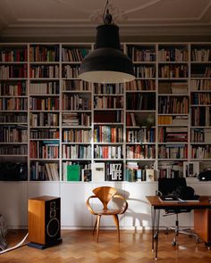 a home office with bookshelves full of books