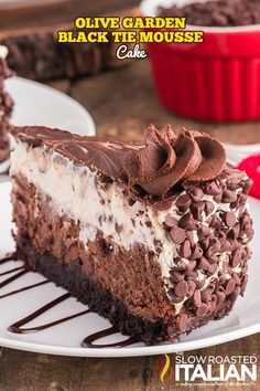 a piece of cake on a white plate with chocolate and oreo toppings in the middle