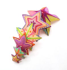 three brightly colored paper stars on a white background