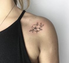 a woman with a flower tattoo on her shoulder