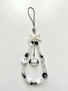 a white and black beaded ornament hanging from a string