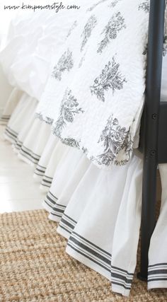 a black and white bed with ruffled bedspread