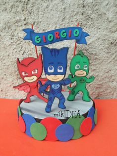 a birthday cake decorated to look like the characters from pj masks and catboy