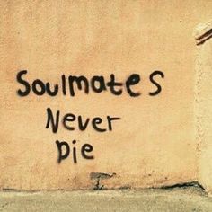 graffiti on the side of a building that says soulmates never die written in black ink