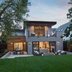 a modern house with an open deck and patio