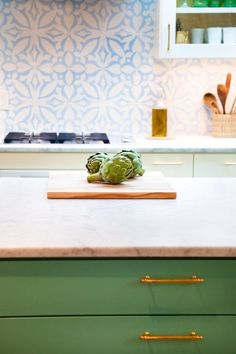 a kitchen counter with a cutting board on top of it next to an oven and cabinets