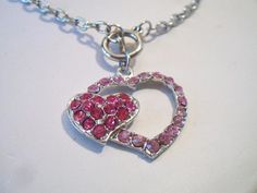 Pink double heart necklace. It measures approx. 19 inches and has a toggle clasp closure. Made with a light pink rhinestone heart silhouette and a smaller solid hot pink rhinestone heart. Silver tone. Perfect for give or wear on Valentine's Day. All sales are final and as is. Thank you for looking. You may also love this: https://www.etsy.com/listing/584789387/heart-silhouette-pendant-necklace?ref=shop_home_active_1 Pink Heart Pendant Necklace For Jewelry Making, Pink Jewelry With Lobster Clasp For Valentine's Day, Valentine's Day Double Heart Jewelry With Lobster Clasp, Pink Double Heart Necklace For Valentine's Day, Valentine's Day Gift Rhinestone Necklace, Valentine's Day Heart Rhinestone Necklace Gift, Pink Adjustable Heart Necklace For Valentine's Day, Pink Heart Pendant Jewelry, Valentine's Day Pink Double Heart Necklace