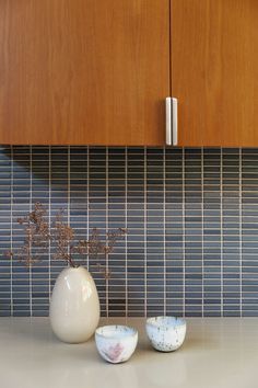 two vases sitting on top of a kitchen counter