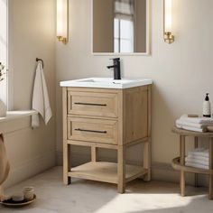 a bathroom with a sink, mirror and towel rack