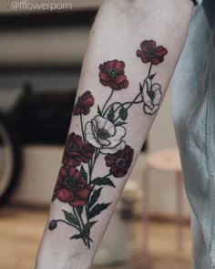 a person with a flower tattoo on their arm