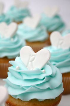 cupcakes with blue frosting and hearts on them