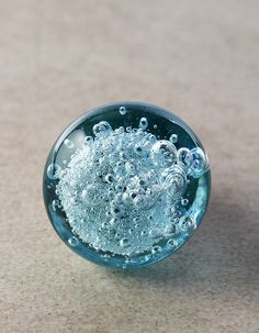 a glass bowl filled with water on top of a table