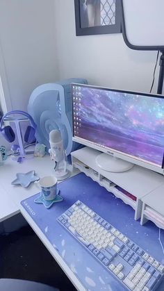 a computer monitor sitting on top of a desk next to a keyboard, mouse and headphones