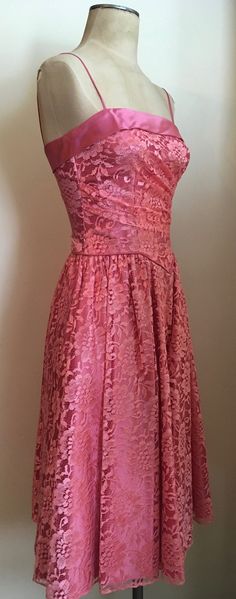 "Beautifully feminine pink lace & satin party dress with basque waist and ruching is a custom made creation from the 1980's. Dress has spaghetti straps, zips up in the back and is lined in satin. Dress is in excellent condition. Chest 32\"-34\" Waist 26\" Hips 44\" plus Length from armpit to hem 35\" All vintage is sold in \"as-is\" condition. We do our best to inspect, correct, and list important flaws. All measurements are made with the garment laying flat. Length is measured from shoulder Party Lace Dress With Lined Bodice, Pink Lace Dress With Fitted Bodice, Pink Lace Dress With Lace Bodice, Strapless Lace Dress For Prom Season, Pink Lace Cocktail Dress, Pink Lace Dress For Prom Season, Pink Dress With Lace Bodice And Spaghetti Straps, Pink Spaghetti Strap Dress With Lace Bodice, Pink Lace Dress With Sweetheart Neckline For Spring