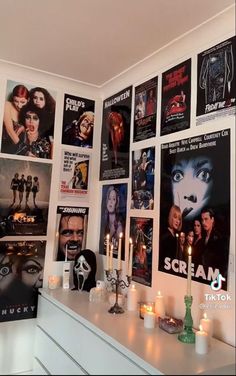 a room with posters and candles on the wall