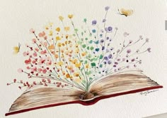 an open book with watercolor flowers on it and butterflies flying over the pages in the background