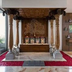 an elaborately decorated room with pillars and red carpet