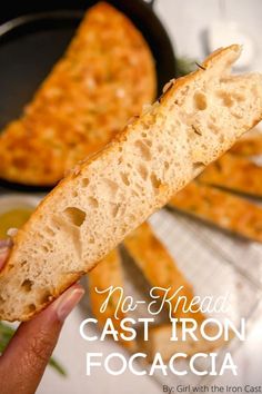 a person holding a piece of bread in their hand with the words no - knead cast iron focaccia on it