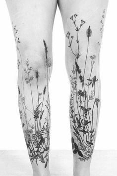 the legs are covered in tattoos with flowers on them, and there is no image to describe