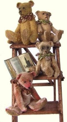 three teddy bears sitting on top of a wooden chair with an open book in front of them