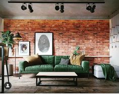 a living room with brick walls and green couches in front of a coffee table