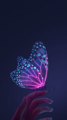 a person's hand holding a glowing butterfly