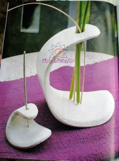 an open magazine with a vase and flowers in it