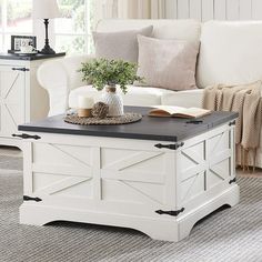 a living room with a white couch and coffee table