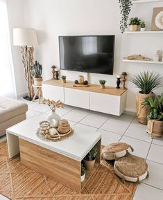 a living room filled with furniture and a flat screen tv on top of a wooden stand