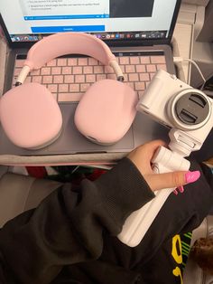 a person sitting in front of a laptop computer with headphones on their headset