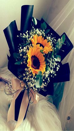 a bridal bouquet with sunflowers and baby's breath