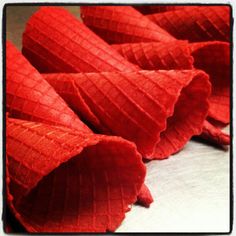 some red flowers are laying on the table together and ready to be used as decorations