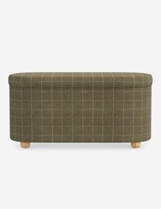 an upholstered bench with wooden legs and a checkered pattern on the back