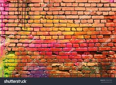 an old brick wall with colorful paint on it