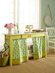 a yellow table with green and white curtains