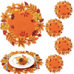 a table setting with place mats, plates and napkins decorated with autumn leaves on an orange background