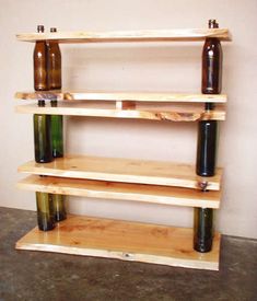 three wooden shelves with beer bottles on them