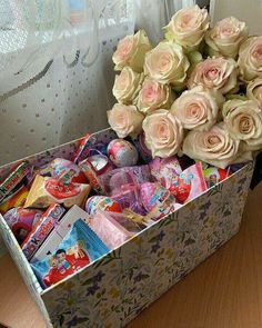 a box filled with lots of candy and flowers