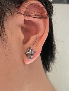 a close up of a person wearing a pair of ear piercings on their ears