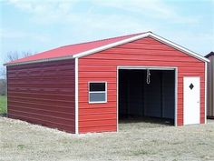 two garages side by side with one door open and the other closed in an empty field