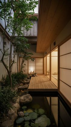 the inside of a japanese house with water and plants on the decking area next to it