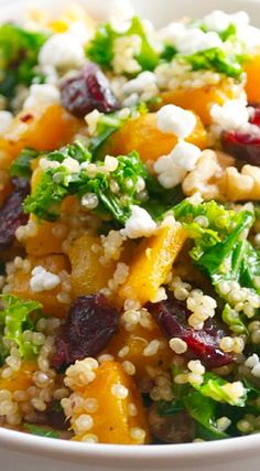 a white bowl filled with vegetables and grains