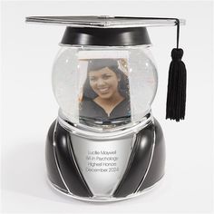 a snow globe with a graduate's photo in it and a tassel hanging from the top