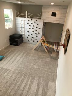 Grey, white, climbing wall with shiplap, hideout, loft, reading book Loft Fort Ideas, Tiny Home Playroom, Playroom Ideas Climbing Wall, Playroom Fort Loft, Barndominium Playroom, Playroom Fort Ideas, Indoor Play Loft, Playroom With Rock Wall, Indoor Loft Playhouse