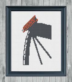 a cross stitch picture with an orange hat on it