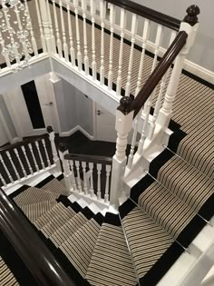 a staircase with black and white striped carpet