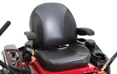 a red lawn mower with black leather seat