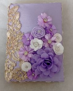 a purple box with flowers on it sitting on a table