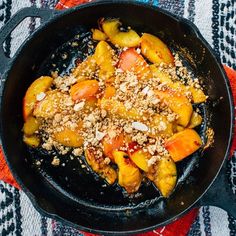 a skillet filled with food sitting on top of a table