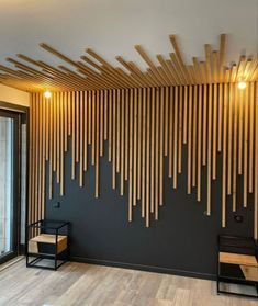 a room with wooden sticks on the wall and wood flooring in front of it